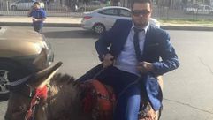 مواطن أردني يركب حمار وهو يرتدي البدلة مقالب فضائية اليرموك ـ فيسبوك