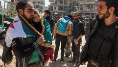 مدنيون سوريون ومقاتلون في الغوطة - جيتي