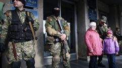 حارسان مواليان لروسيا يقفان خارج مبنى الإدارة الإقليمية في شرق أوكرانيا – ا ف ب