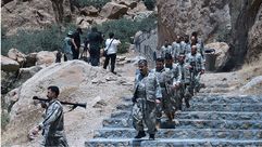 مقاتلو الحزب يخرجون من الكهف لحظة تسليم السلاح- جيتي