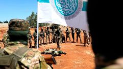 عناصر من هيئة تحرير الشام خلال تدريبات في إدلب- جيتي
