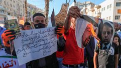 محتجون فلسطينيون في رام الله يحرقون صورة محمد دحلان وابن زايد رفضا لتطبيع رفضا لتطبيع الإمارات- جيتي
