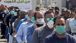 كورونا  الكويت  إصابات  الوقاية  فيروس  وباء- جيتي