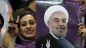 مؤيدة لروحاني تحمل صورته أثناء حملته الانتخابية في طهران - أ ف ب