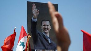 صور بشار الأسد بأيدي أنصاره في دمشق - ا ف ب