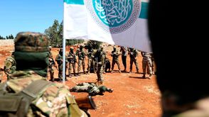 عناصر من هيئة تحرير الشام خلال تدريبات في إدلب- جيتي
