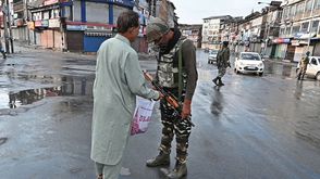 جندي هندي يفتش متعلقات لأحد سكان كشمير بعد إلغاء الحكم الذاتي فيها- جيتي