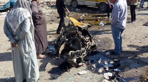 بقايا سيارة انفجرت في محمع حافلات صغيرة في منطقة المشتل بالعاصمة بغداد - أ ف ب