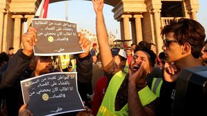 محتجون يقفون أمام مبنى مجلس محافظة البصرة قبل أن تفرقهم القوات الأمنية- جيتي 