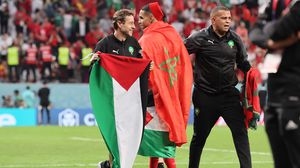 إداريون في المنتخب المغربي يحملون علم فلسطين بعد فوزهم- جيتي