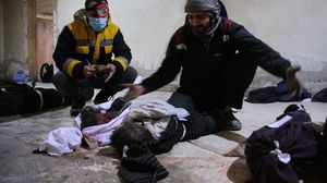 أب يبكي أمام جثث أطفاله الذين راحوا ضحية قصف النظام على حمورية بالغوطة الشرقية- جيتي
