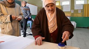 سيدة تونسية تستخدم الحبر الأزرق بعد إدلائها بصوتها في الانتخابات الماضية- جيتي