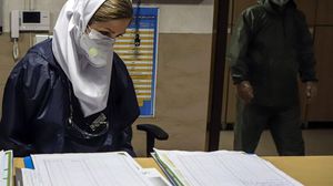 ممرضة تراجع سجلات المصابين بالفيروس في أحد المستشفيات الإيرانية- إرنا