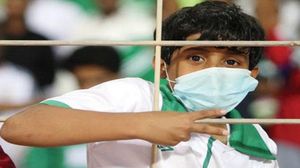 فتى سعودي يرتدي كمامة أثناء حضوره مباراة الديربي - (أرشيفية)