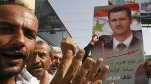 مؤيدو بشار الأسد يحملون صوره خلال الانتخابات الرئاسة الماضية- أ ف ب