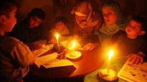 عائلة مصرية  تذاكر لأبنائها على ضوء الشموع - (أرشيفية)