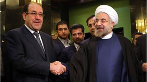 الرئيس الإيراني حسن روحاني (يمين) مستقبلا المالكي في إيران - أرشيفية
