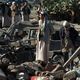 عناصر حوثية فوق ركام أحد مقراتهم بعد قصف طائرات التحالف - أ ف ب