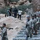 مقاتلو الحزب يخرجون من الكهف لحظة تسليم السلاح- جيتي